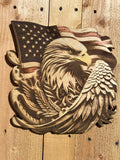Wooden carving of an eagle holding an American flag on a wooden background