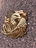 Metallic eagle emblem with American flag on a textured surface