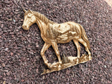 3D illusion double exposure of a horse with a mountain scene inner image, laser burned into wood.  Shown at an angle and laying on a gravel backdrop.